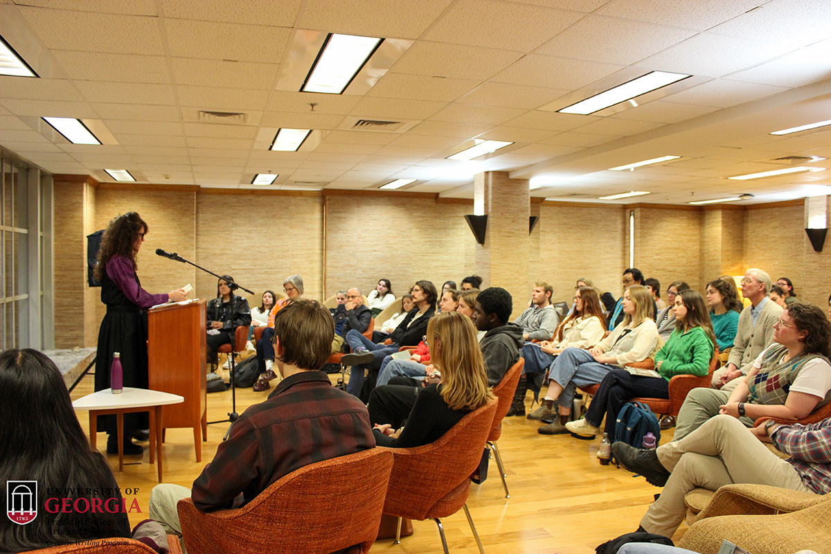 photo of woman at lectern, with audience