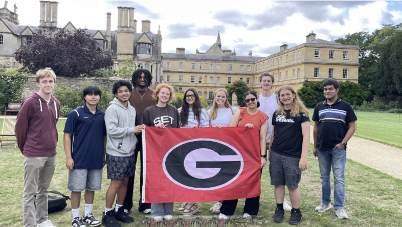 Pictured: Computing students holding up flag at Oxford 