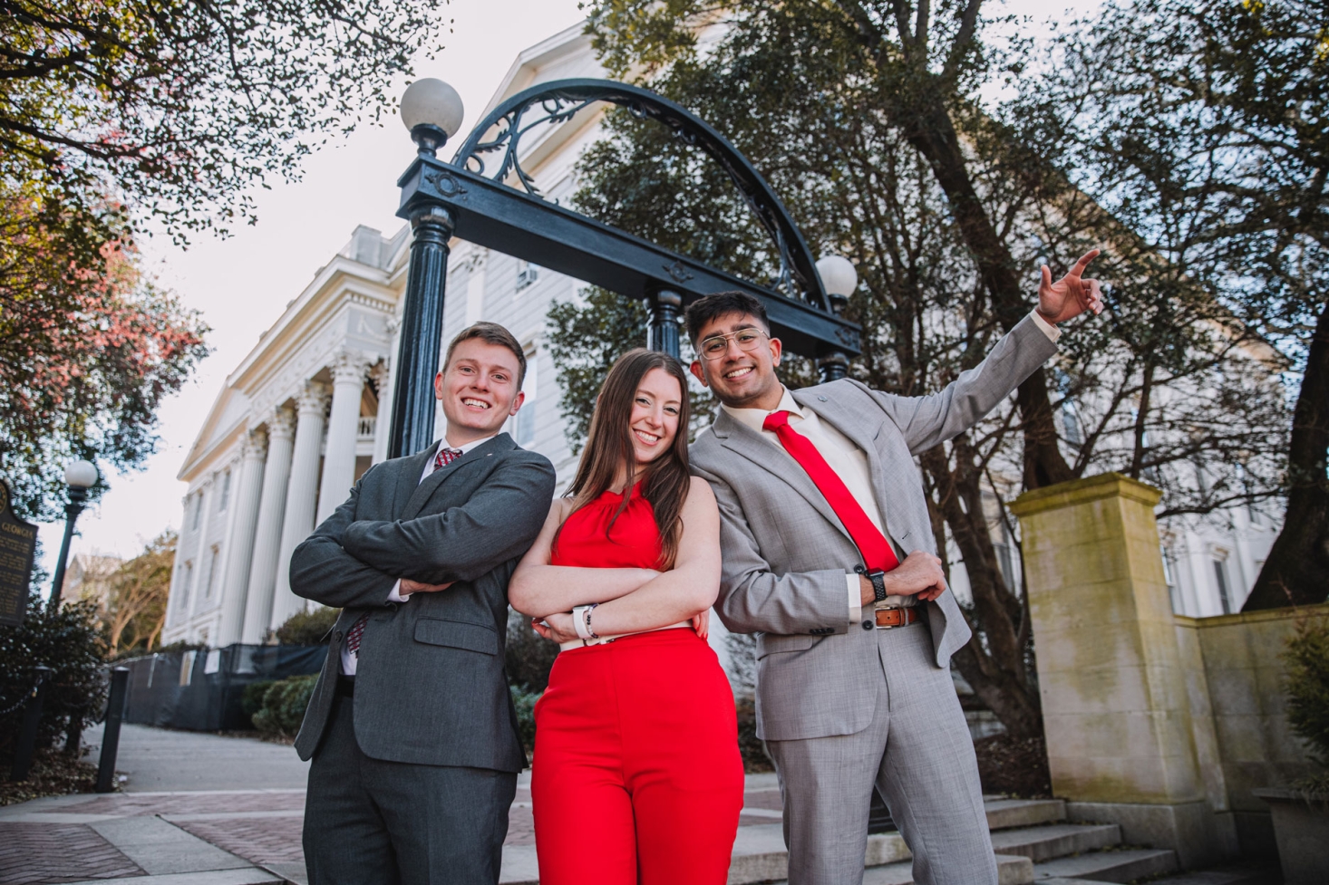 SGA senators pose in front of the arch