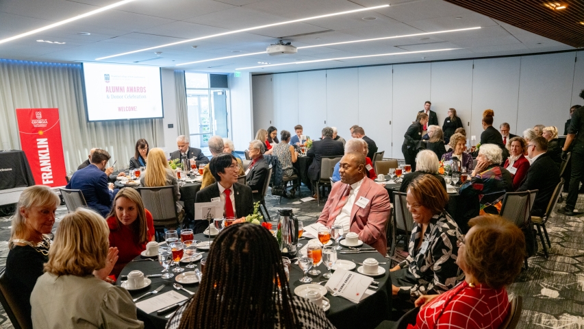 wide photo of people at tables