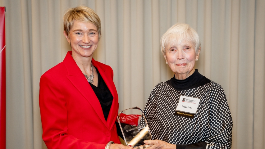 Photo of two women holding award