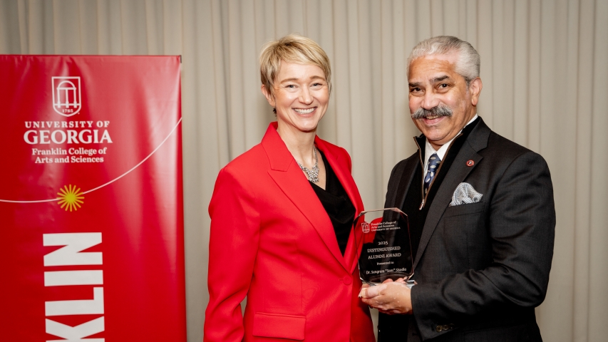 Photo of two people holding award