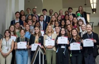 photo of large group of people holding certificates