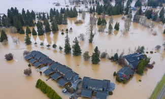 photo of area with flooding and house rooftops