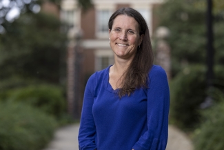 photo of woman outdoors, blurred gates in background