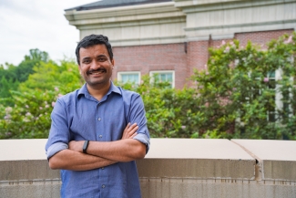 photo of man standing on building porch, day