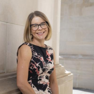 photo of woman, outdoors, with building