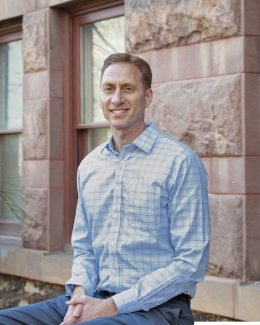 photo of man, building in background