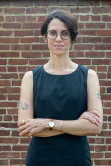 photo of woman, brick wall in background