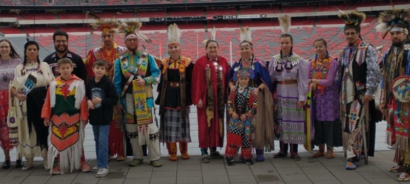 photo of Native Americans in indigenous dress at stadium