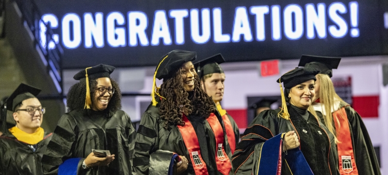 photo of graduates in caps and gowns, regalia