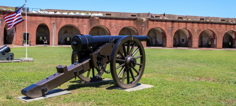 photo of interior of old fort, with cannon and grass