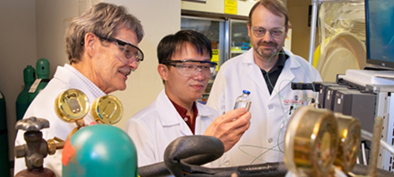 photo of three men in a lab