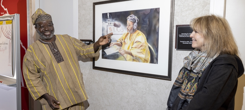 photo of two people and painting