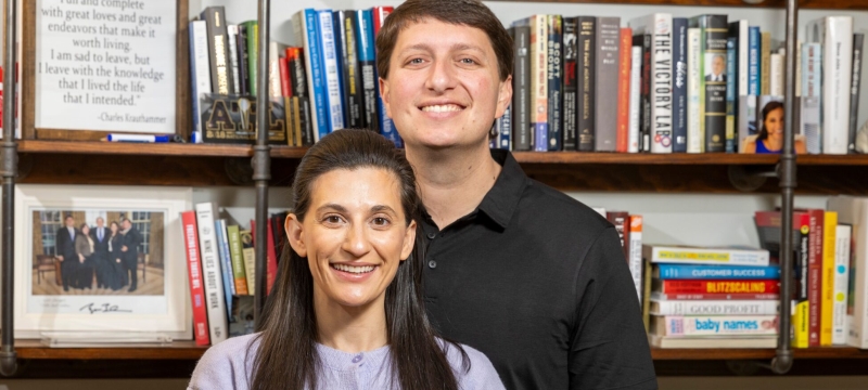 photo of man and woman, bookshelves in background