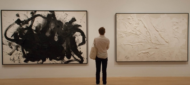 photo of person in gallery between two large partings