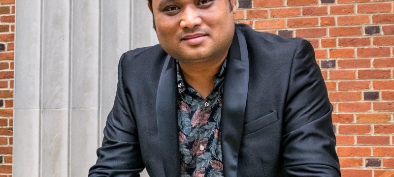 photo of man with brick building background
