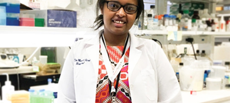 woman in white coat in lab