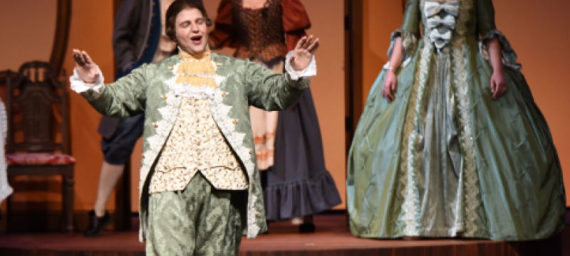 photo of singers in 19th century costumes on stage