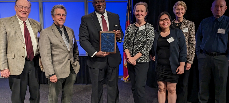 group photo of seven people on stage