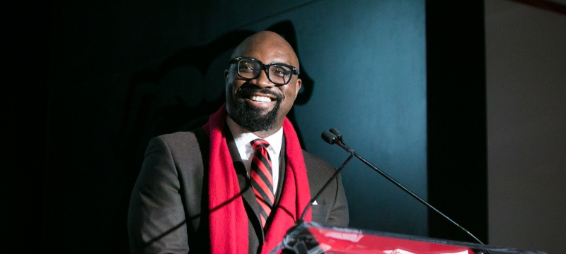 photo of man speaking at podium