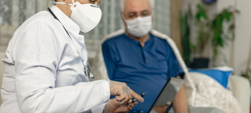 photo of masked nurse with masked patient