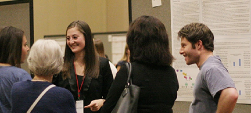 students talking near a poster