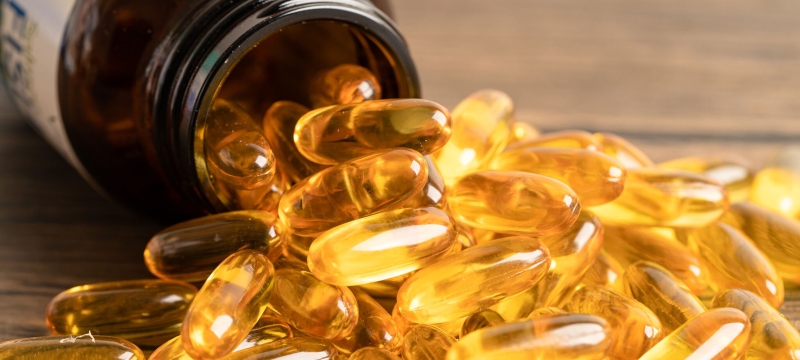 photo of vitamins spilling out of bottle