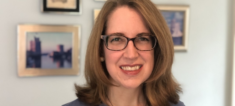photo of woman, with framed images in background