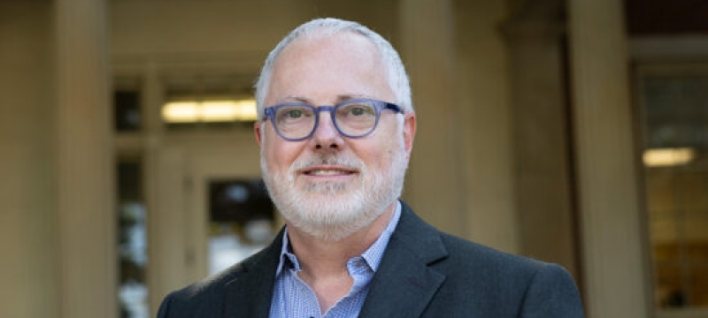 photo of man, building in background