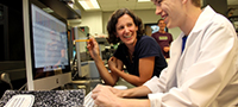 teacher and student with computer