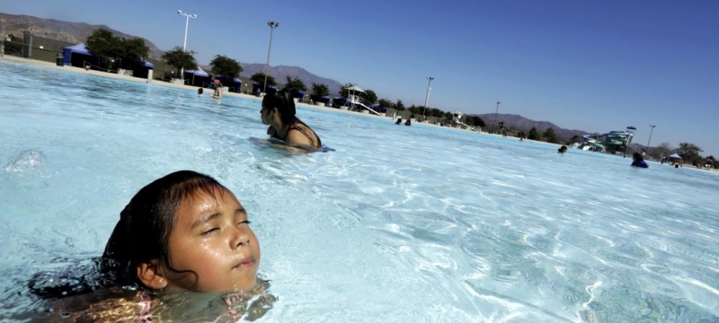 photo of woman and child in pool, day