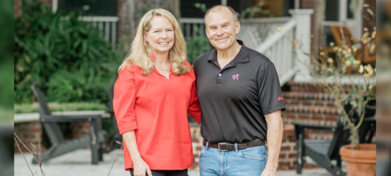 photo of two people, outdoors, steps and porch in background