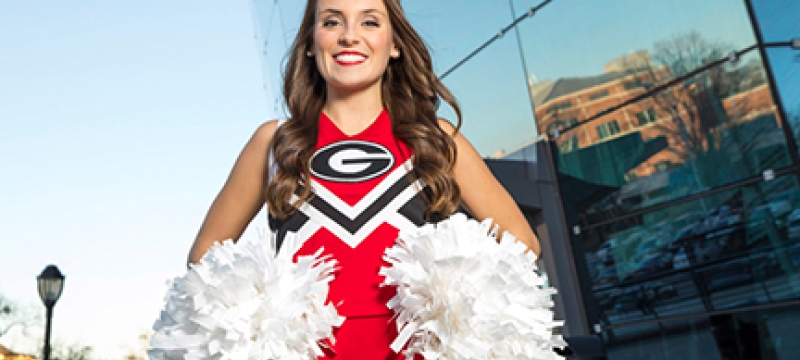 photo of cheerleader in front of coliseum