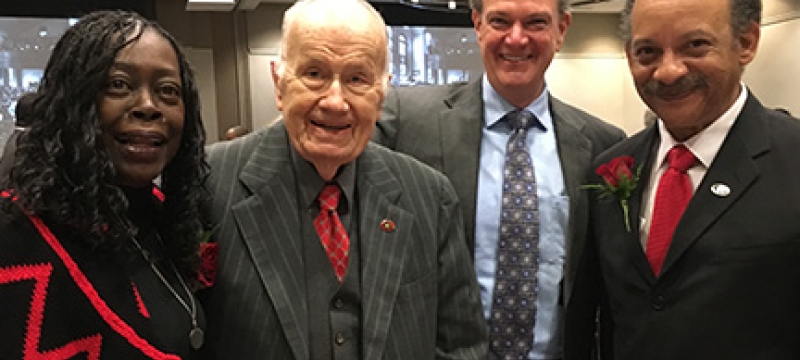 four people in a ballroom