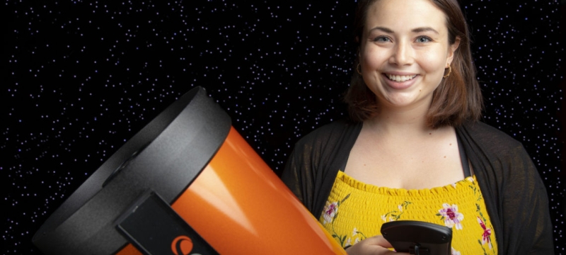photo of woman with telescope and starry background