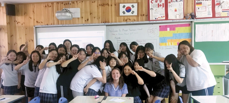 photo of woman with students in classroom