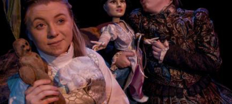 actors with puppets in period costume