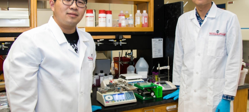 Photo of two men in lab coats