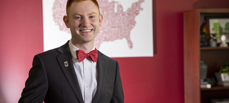 photo of man, map on wall in background