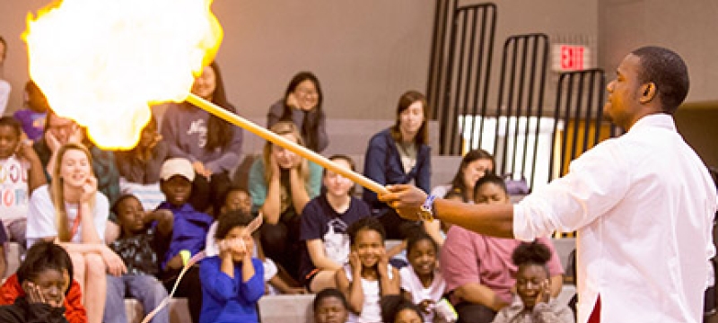 man, with students and fire demo