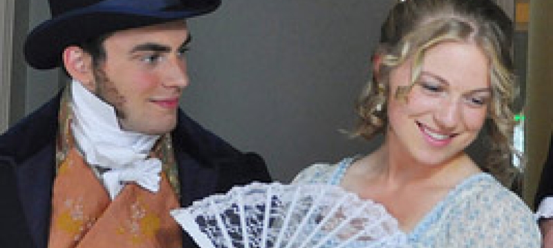 smiling man, woman with fan