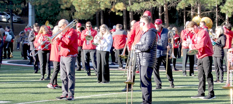 photo of people on field with band instruments