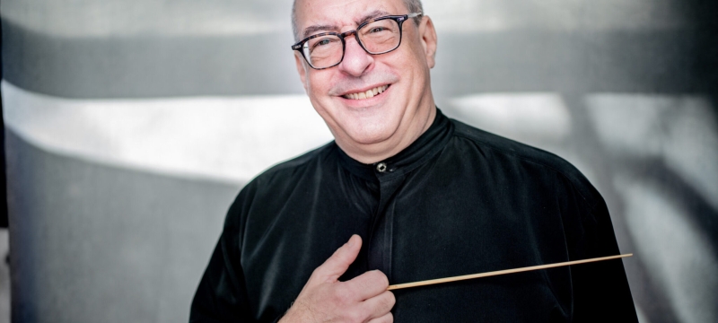 photo of man holding conductor's baton