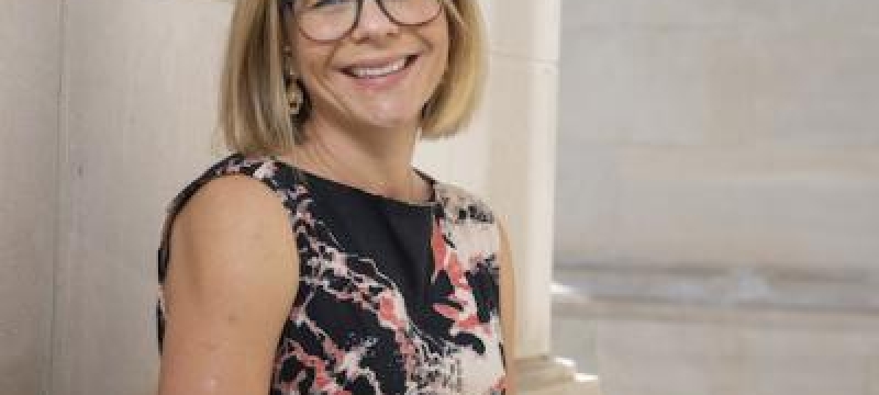 photo of woman, outdoors, with building