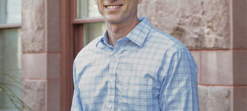 photo of man, building in background