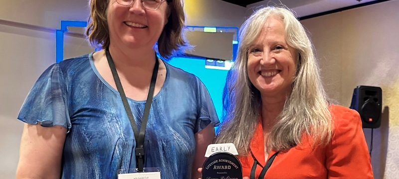 photo with two people, one with award