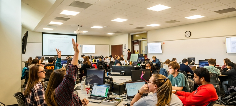 photo of people in classroom, with computers and projection screen