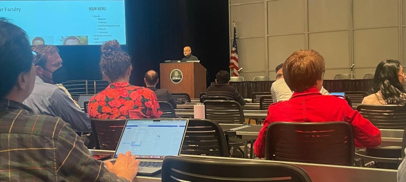 photo of conference and speaker at podium