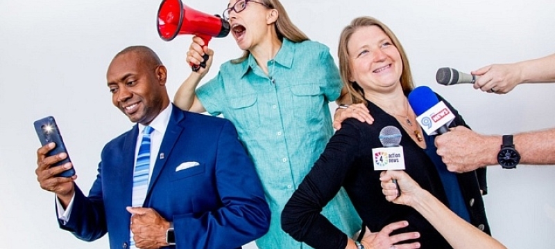 photo of man and two women, microphones, 